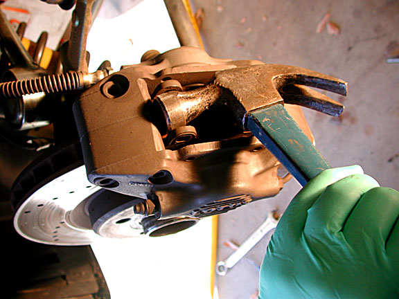 using hammer to pry apart brake cylinders